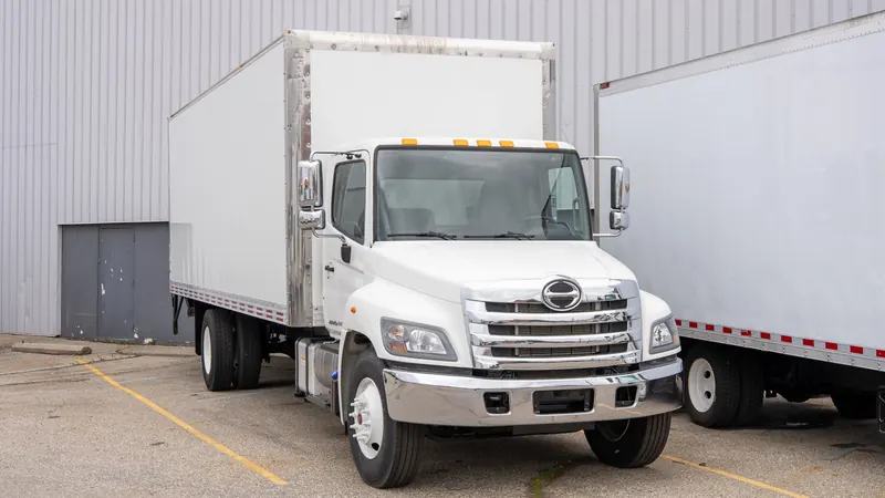 White box truck outside the shop
