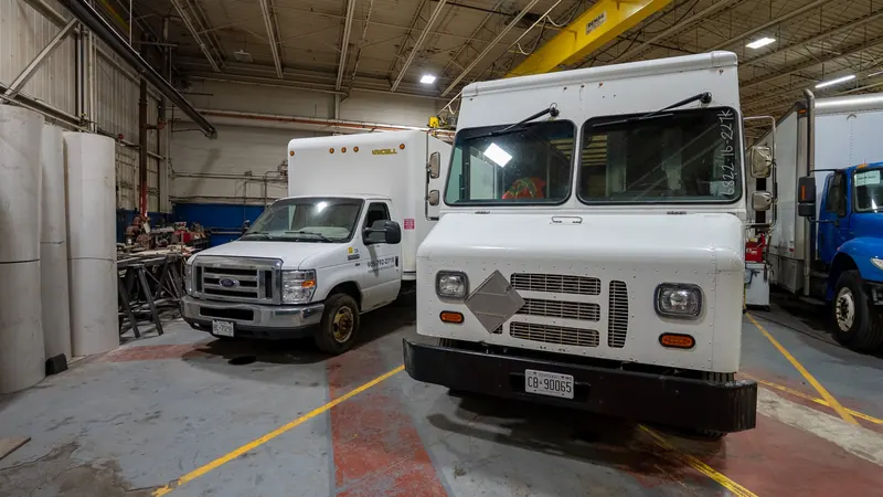Step van and box trucks in the shop
