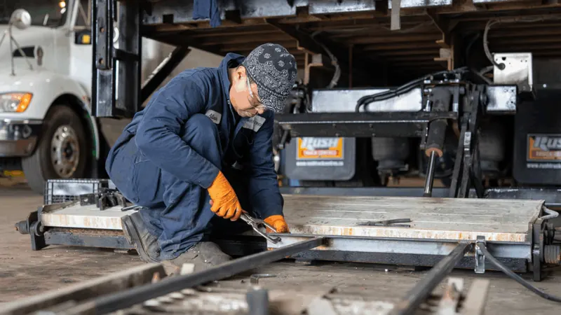 Technician working on an aluminum walk ramp